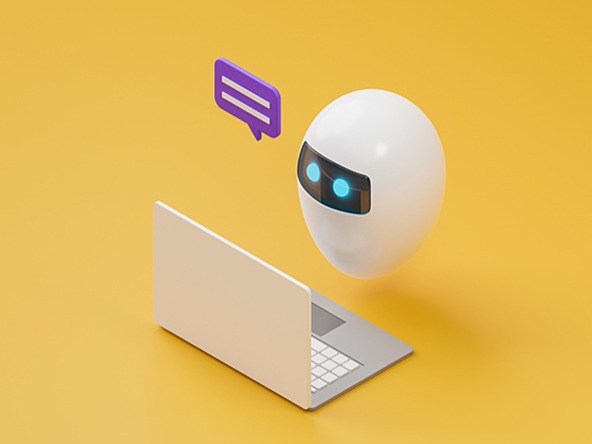 robotic chatbot figure next to a laptop with speech bubble